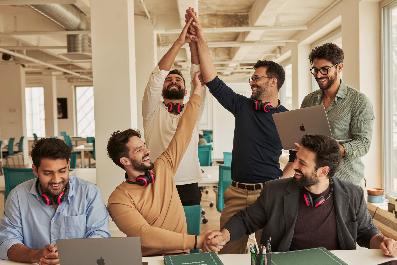 The SDR team high-fiving in the office after booking a meeting